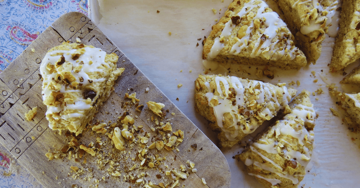 a black walnut scone with chopped nuts on a wood board